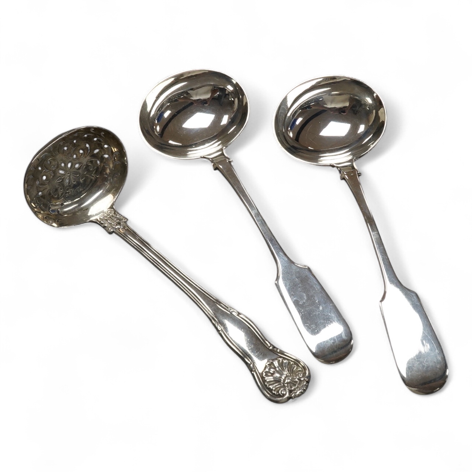 A pair of Victorian silver fiddle pattern sauce ladles by John Stone, Exeter, 1856, 75m, together with a Victorian silver sifter spoon, Mary Chawner, London, 1835. Condition - fair to good